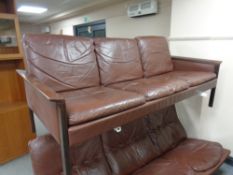 A 20th century Danish wood framed brown leather three seater settee