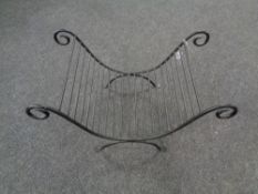 A wrought iron log stand