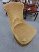 A 19th century nursing chair upholstered in a gold dralon