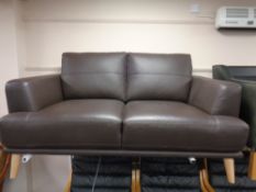 A contemporary brown leather two seater settee