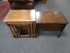 A nest of three oak tables together with an oak storage stool