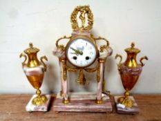 A three piece antique French decorative brass and marble clock garniture with pendulum and key