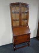 A 20th century oak bureau bookcase with leaded glass doors