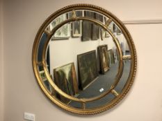An ornate gilt-framed circular mirror,