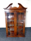 A mahogany wall mounted double door display cabinet