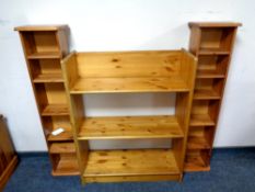 A set of pine open shelves together with two media stands