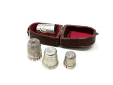 Four antique silver thimbles, one boxed,