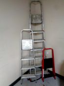 A seven step aluminium folding ladder together with two further pairs of folding steps