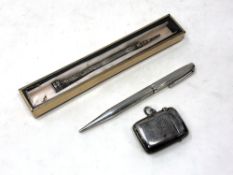 A silver pencil, pen,
