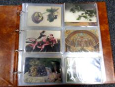A postcard album containing a quantity of early 20th century postcards,