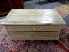 A pine coffee table fitted with four drawers, width 109 cm.