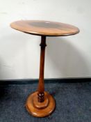 A 19th century beech wood wine table on paw feet