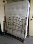 A contemporary 4'6 chrome metal bed frame with mattress