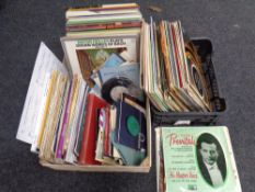 Two baskets containing a quantity of vinyl LPs and seven inch singles together with a quantity of
