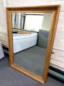 An ornate gilt framed overmantel mirror