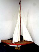 A large wooden model of a pond yacht on stand,