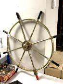 A heavy brass eight-spoke ship's wheel, overall diameter 90 cm.