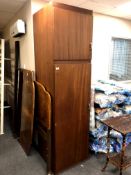 A mid 20th century teak effect wardrobe fitted cupboard above,