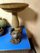 A concrete garden bird bath