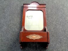 An Edwardian mahogany hall mirror with storage trough