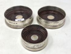 A trio of Elizabeth II silver wine bottle coasters, Broadway & Co, Birmingham 1989,