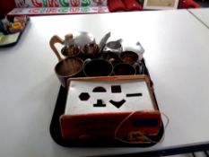 A tray of Picquot ware, stainless tea service, stainless steel and silver plated tankards,