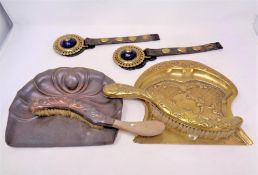 Two Edwardian brass and copper crumb brushes with trays together with a pair of martingales