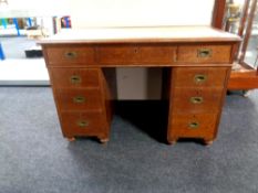 A late 19th century oak pedestal campaign desk,