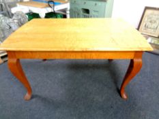 A 20th century continental dining table on cabriole legs