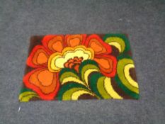 A mid century wool rug, 112cm by 73cm.