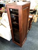 A contemporary display cabinet on swivel base with glass door to each side,