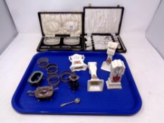 A tray containing four items of crested china, silver plated napkin rings and cruet,