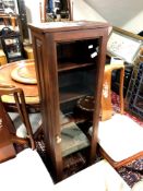 A contemporary glazed narrow cabinet,