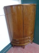 A mid 20th century double door corner cabinet fitted four drawers beneath on raised legs