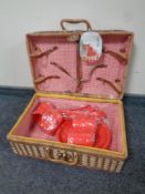 A plastic picnic set in wicker case