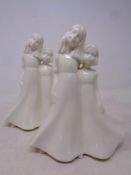 A pair of Royal Worcester Moments figures,