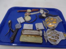 A tray containing vintage AA badges, assorted wristwatches, lighters,