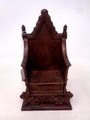 A 1953 Queen Elizabeth II Harper cast iron Coronation money box in the form of a throne