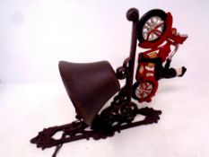 A cast iron vintage motorcycle wall bracket with bell