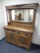 An Edwardian oak Arts and Crafts sideboard