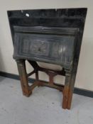 An antique cast iron fire insert