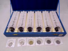 A coin collector's case containing a quantity of American quarter dollars and Euro coins