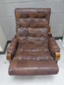 A 20th century Scandinavian stained beech framed armchair upholstered in a brown button leather
