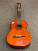 A Cortez six-string acoustic guitar.