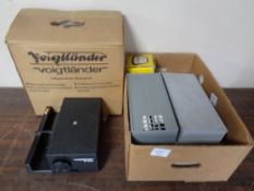 A Volgtlander projector (boxed) together with a box containing slides in cases and a Halina viewer