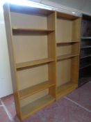 A pair of oak effect open bookshelves