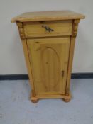 A pine pot cupboard fitted a drawer