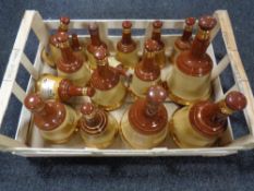A crate containing a quantity of Bells Scotch Whisky decanters (empty)
