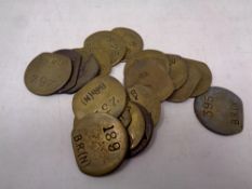 A bag containing eighteen vintage transport tokens