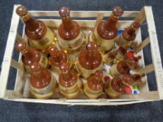 A crate containing a quantity of Bells Scotch Whisky decanters (empty)